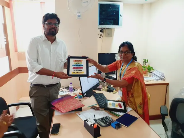 Vijay Arjun V with an LIC HFL official at a branch office