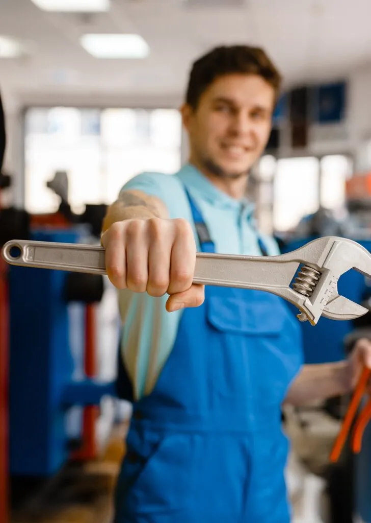 Plumber Shows Pipe Wrenches In Plumbering Store TTCTX97